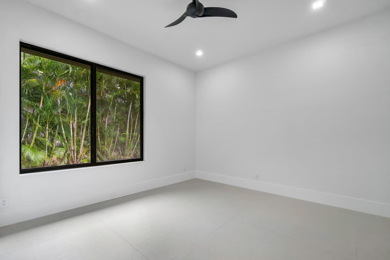 Bedroom with large black-frame impact picture window