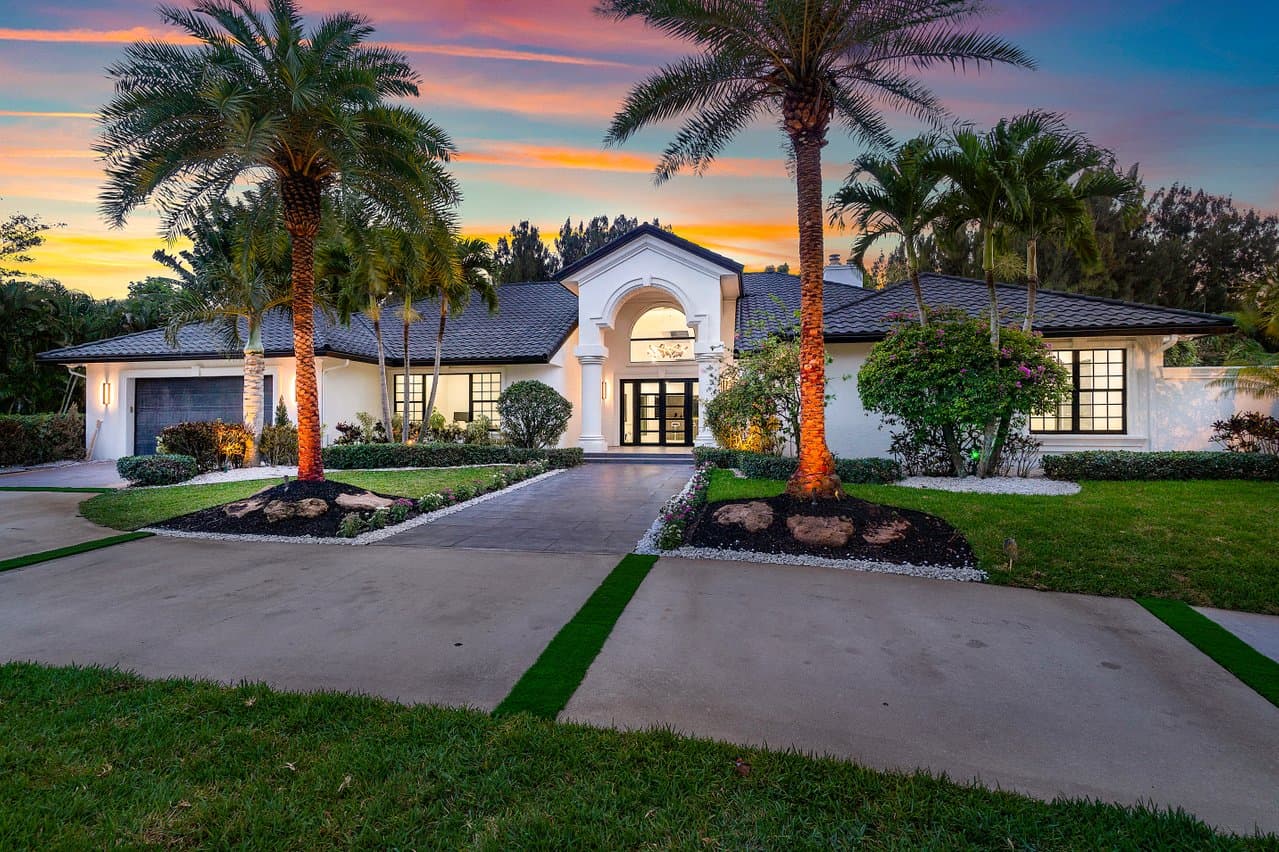 Mediterranean estate with black-frame impact windows at dusk
