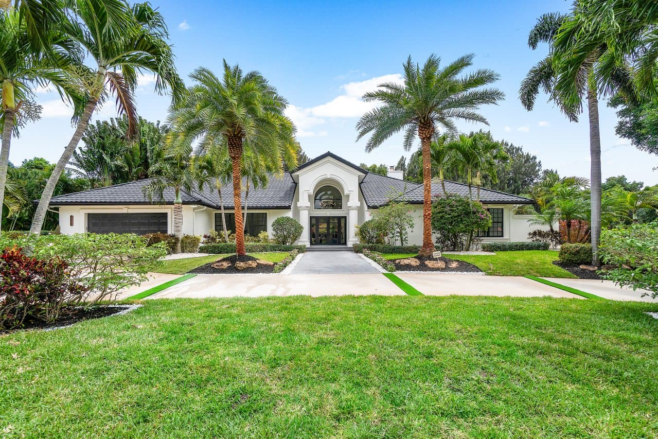 Estate home front elevation with black impact windows