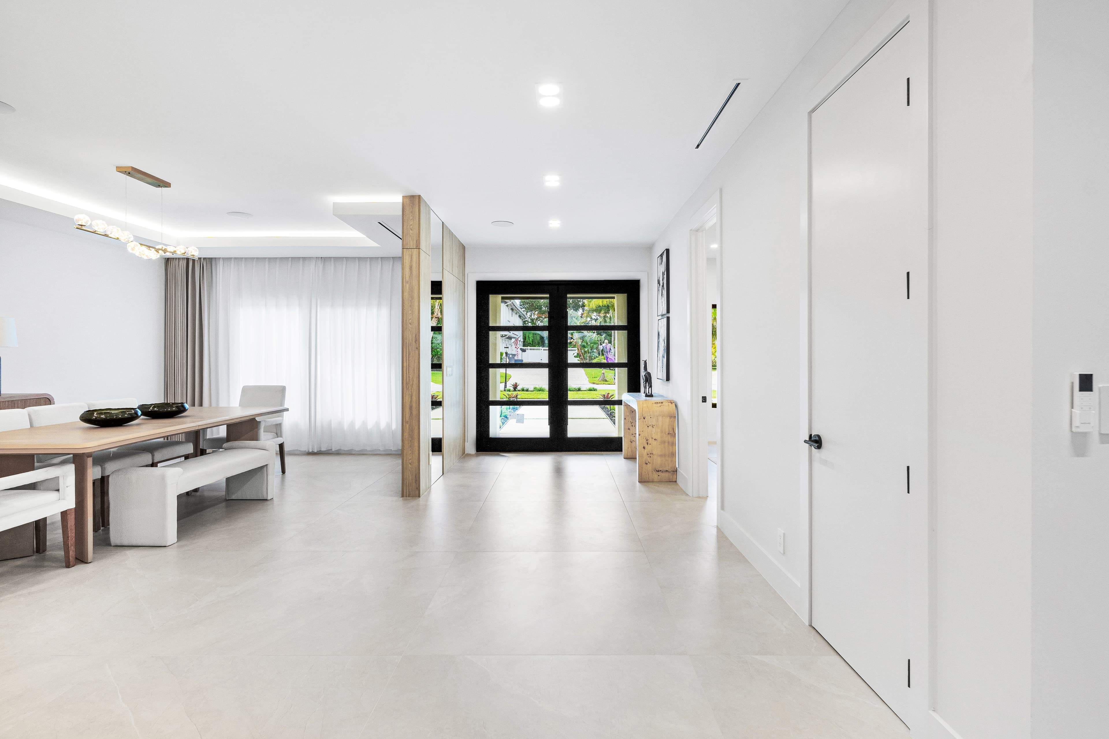 Home entry foyer with black impact French doors