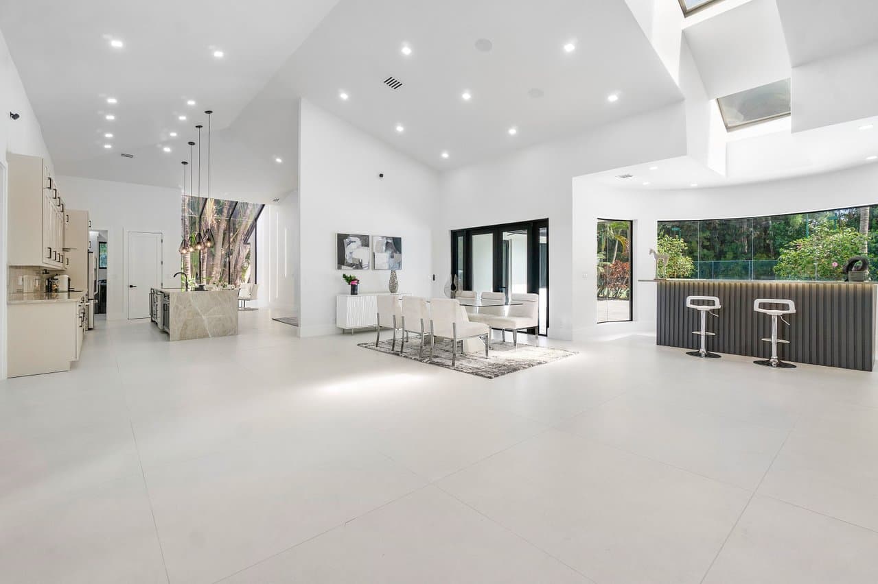 Open-plan living area with black impact windows and sliding doors