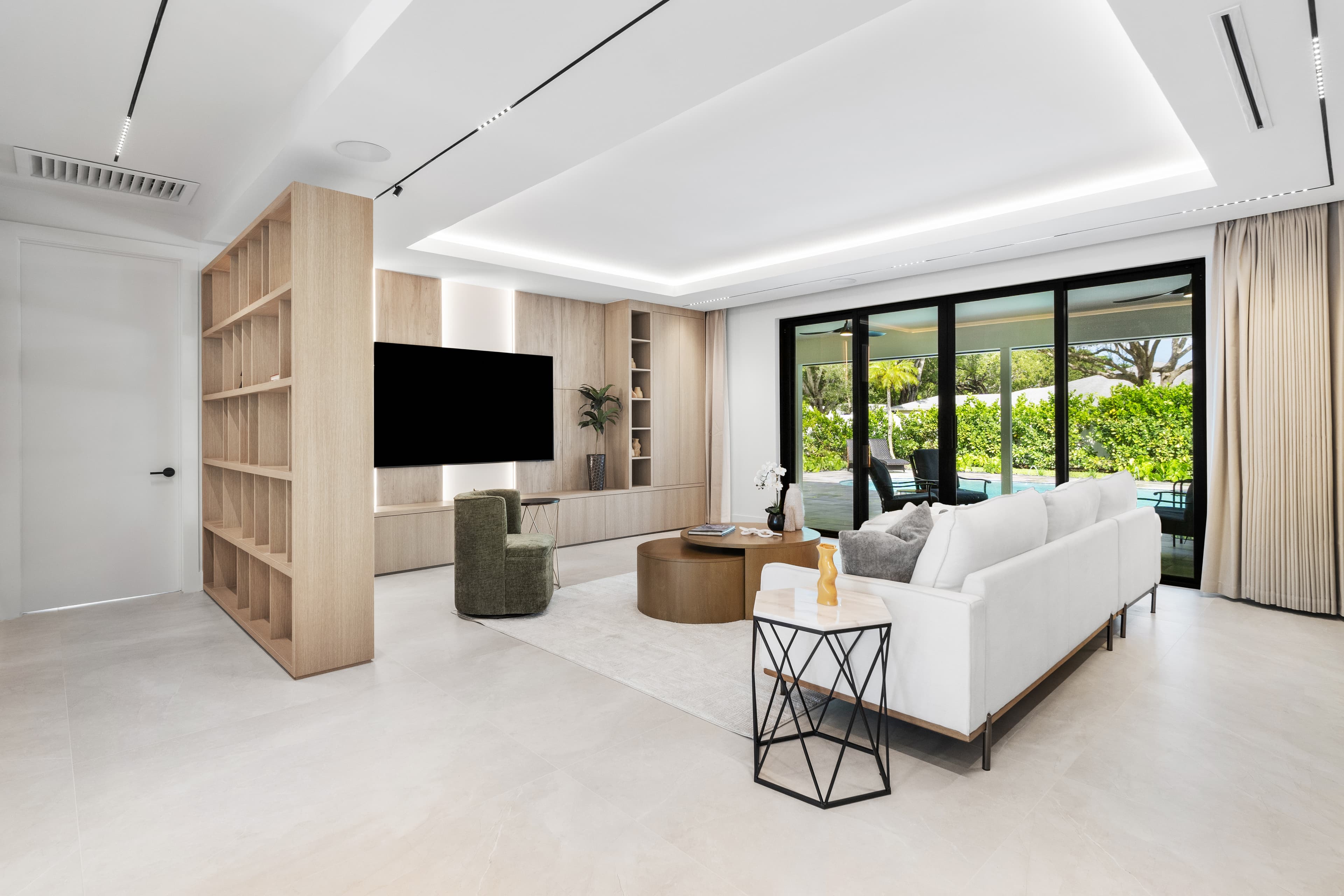 Family room with impact sliding glass doors overlooking pool