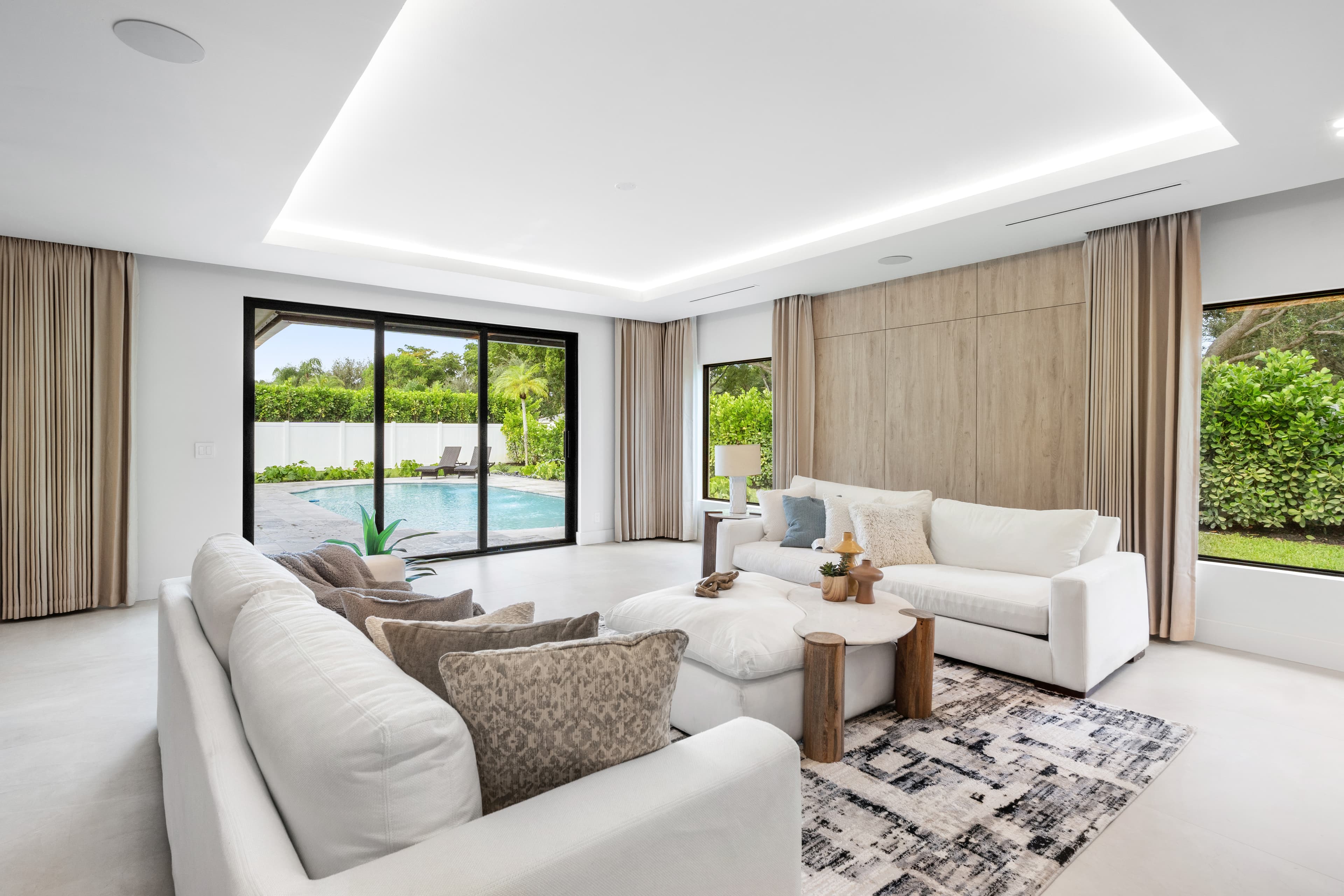 Living room with impact sliding glass door and picture windows