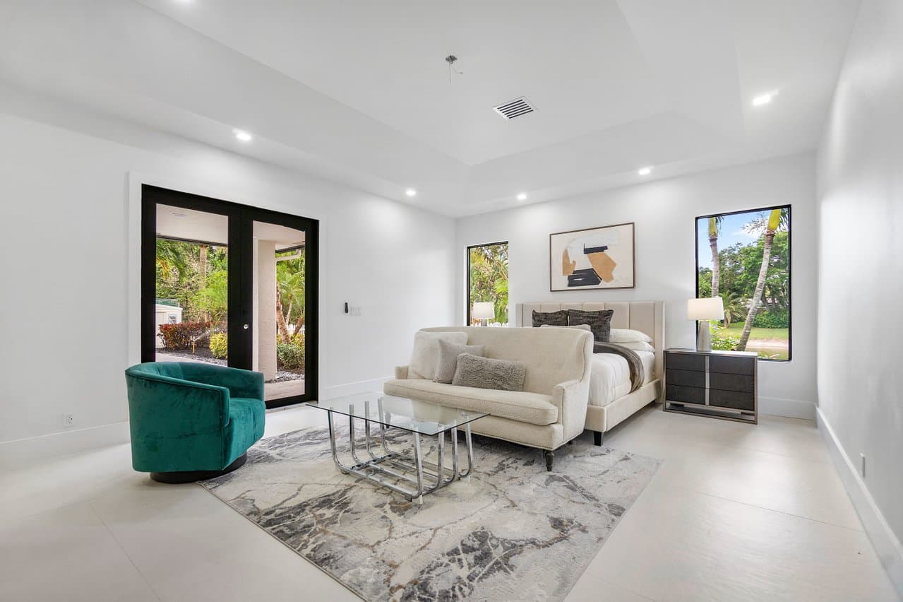 Master bedroom with black impact French doors and picture windows